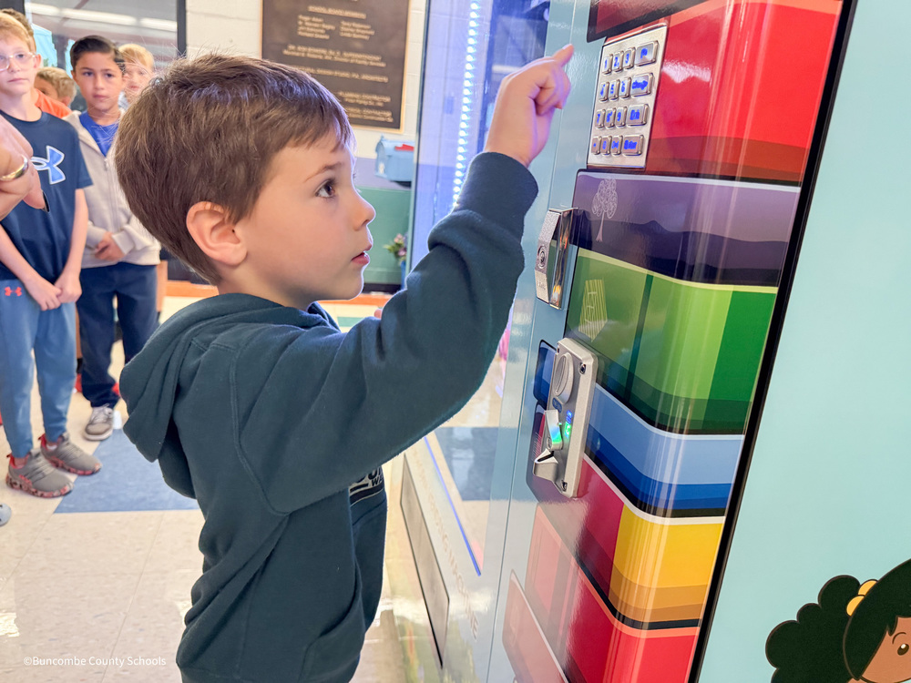 student using the book machine