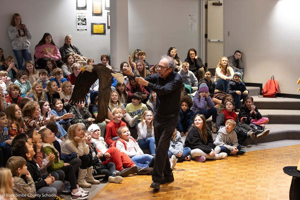 Hobey Ford flying a puppet eagle around the auditorium. 