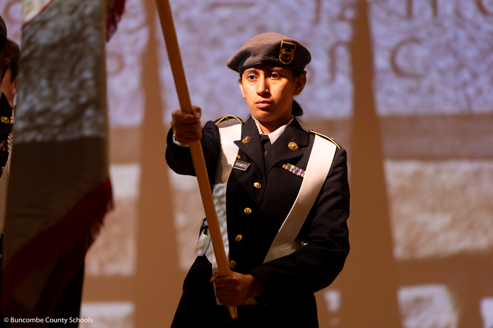 JROTC student holding a flag. 