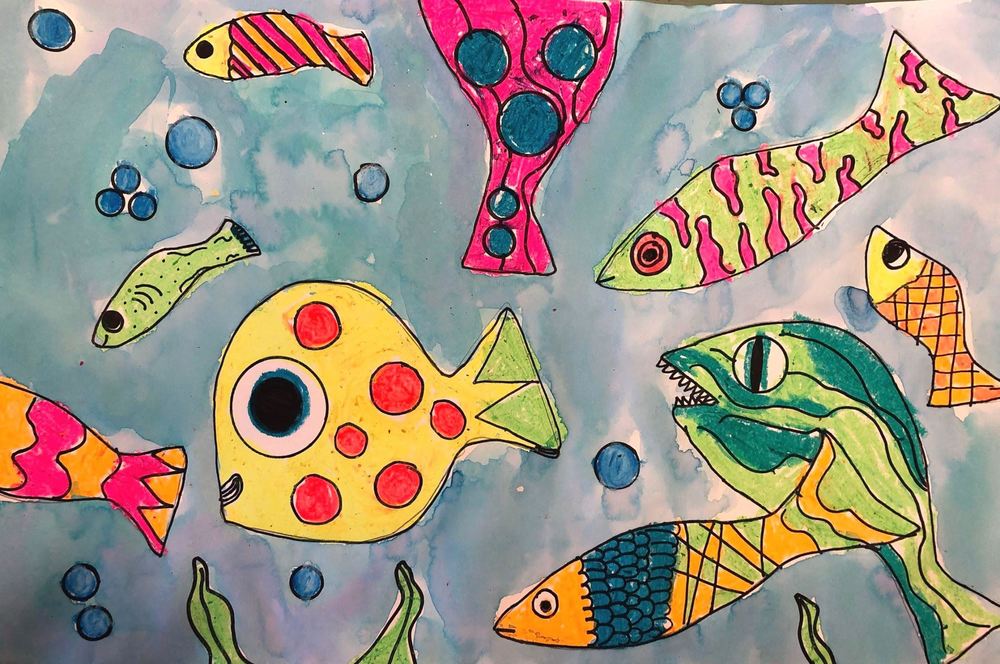 Artwork done by a third grader of fish swimming in the ocean. 