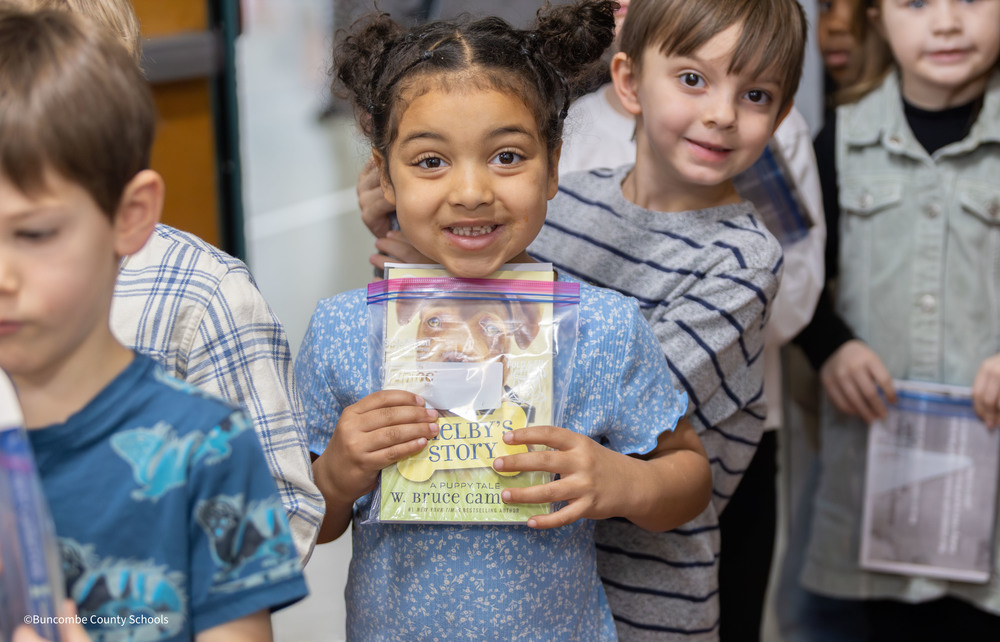 Girl holding "Shelby's Story" book