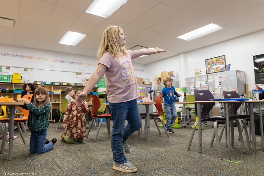 Second graders balance on one foot.