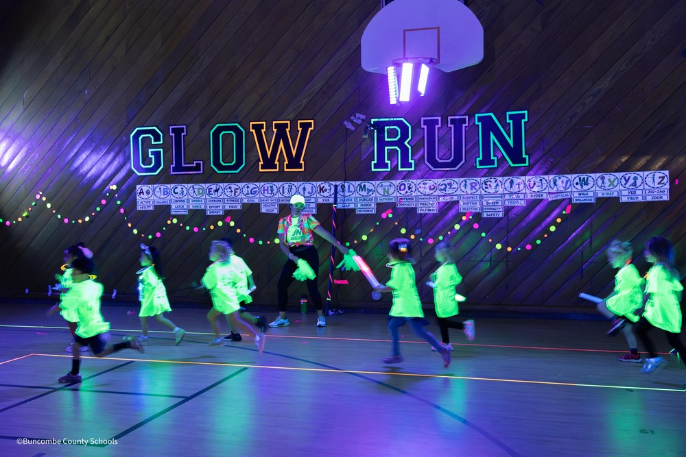 students run with glow in the dark t-shirts during the glow run