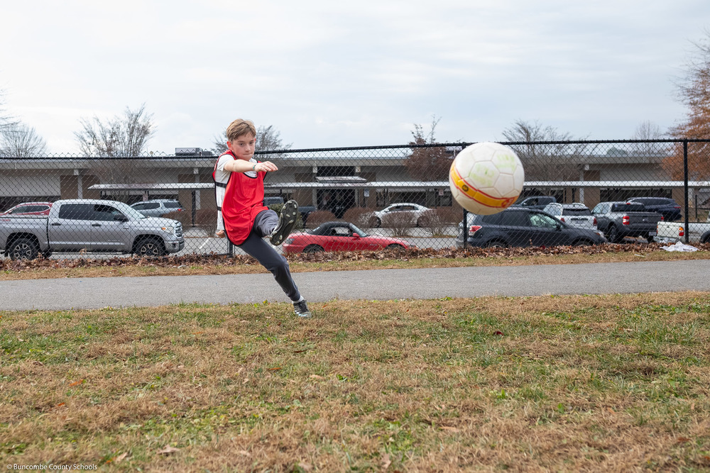 A student kicks a soccer ball at Eblen Intermediate.