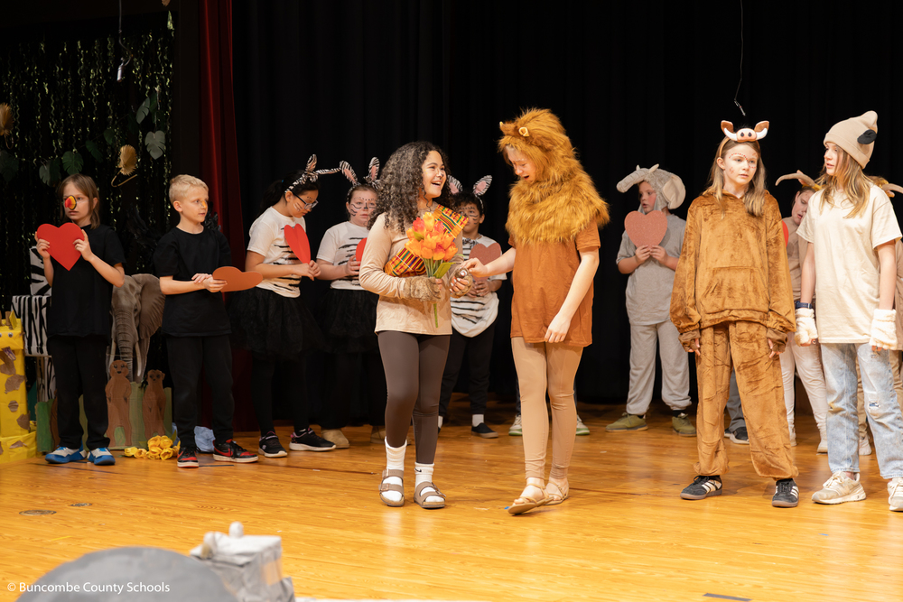 Students on stage performing the Lion King Jr. 