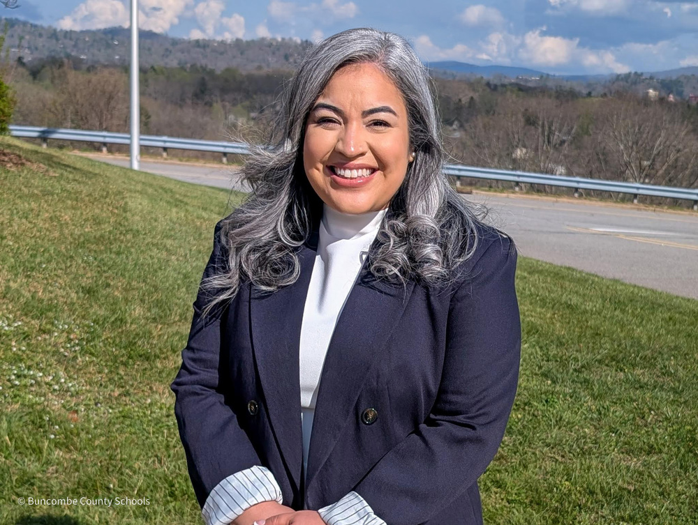 Photo of Assistant Principal standing outside and smiling for the camera. 