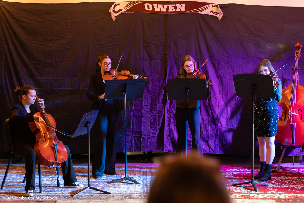 A quartet of students performing a song. 