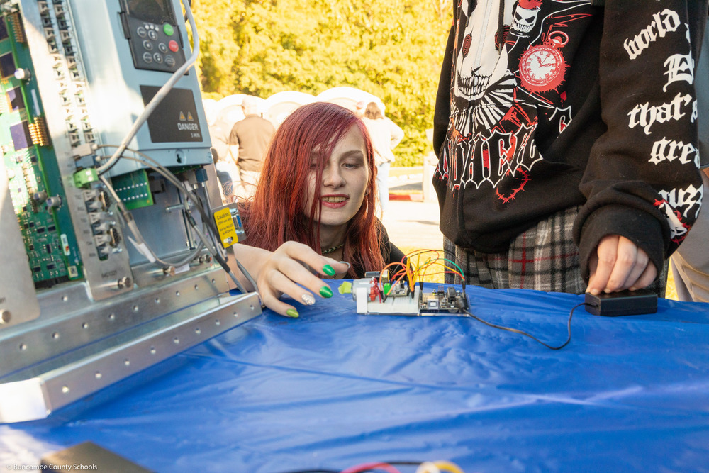 A student examines an electrical component.