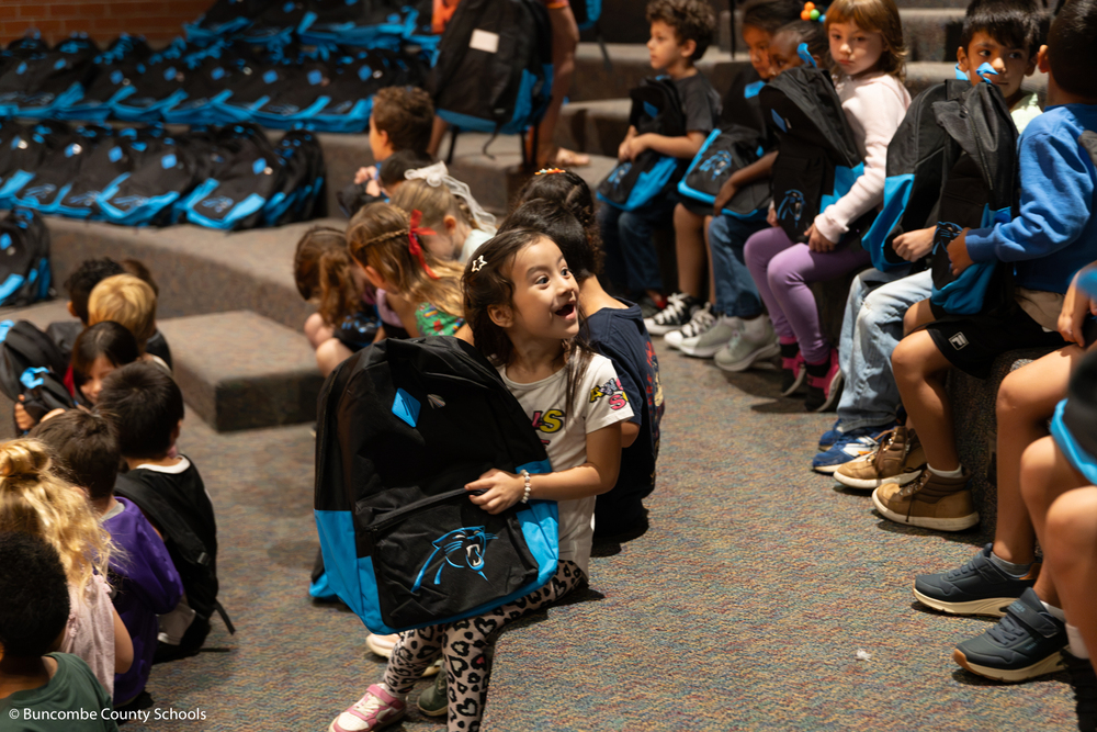 Student excited to get her new Panthers backpack. 