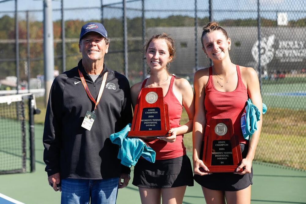 North Buncombe Tennis Coach with Natalia and Aubrey after their state championship win. 