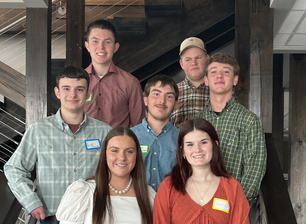 A group of WNCStrong students posing for a photo on the steps of Brookstone Church