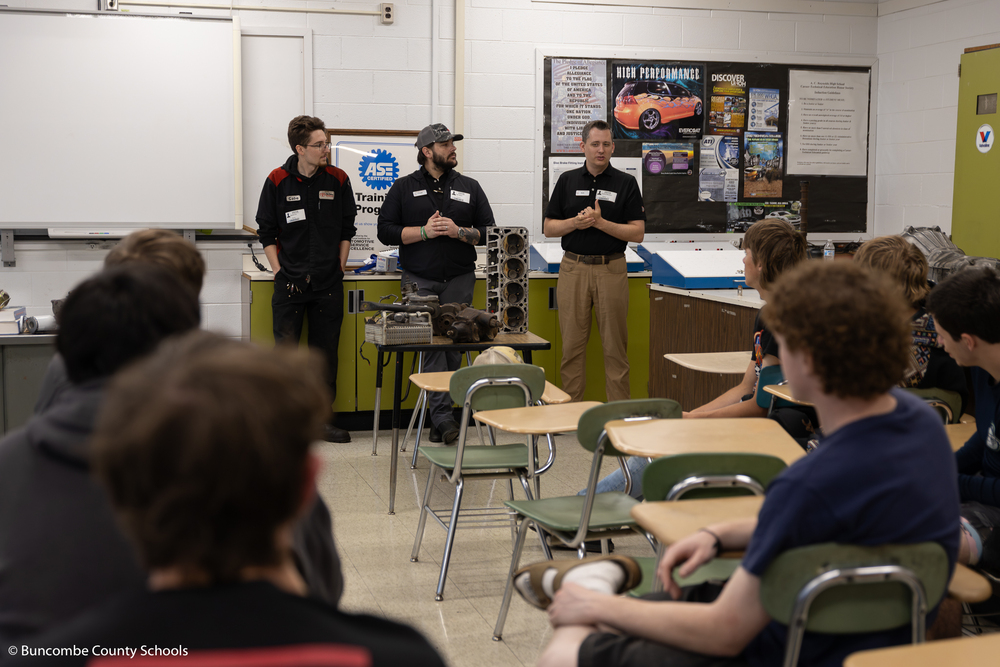 Former A.C. Reynolds graduates talking to automotive students about career opportunities. 
