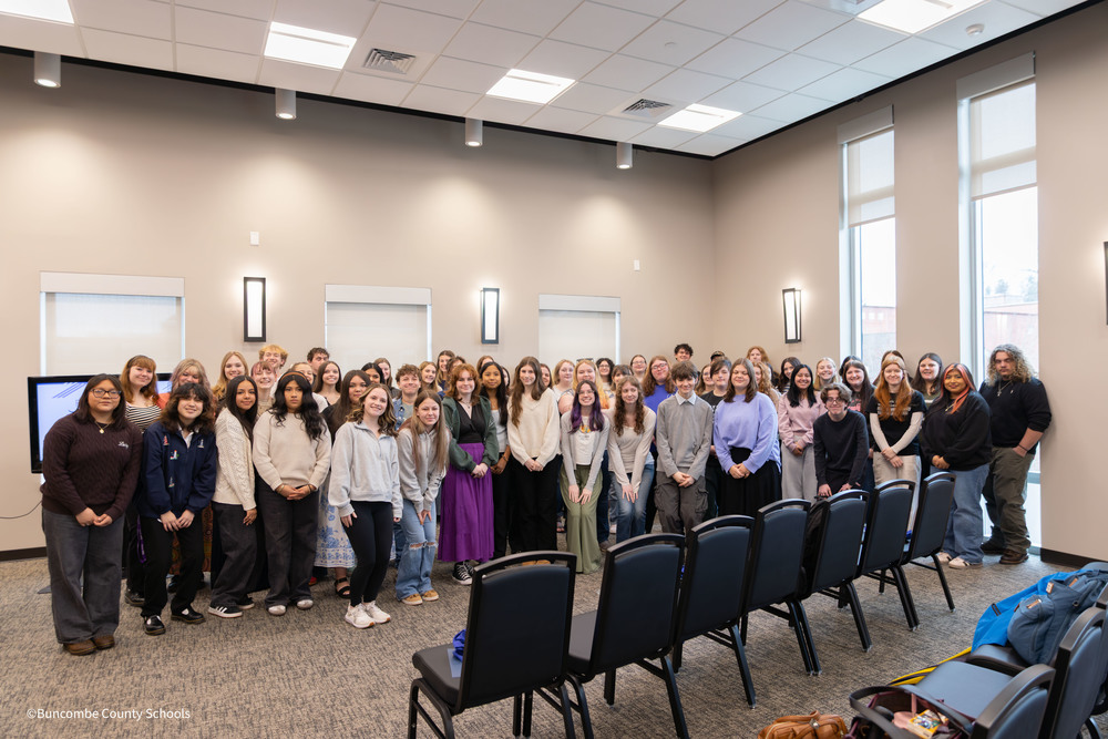 65 Students gathered for a photo in conference room