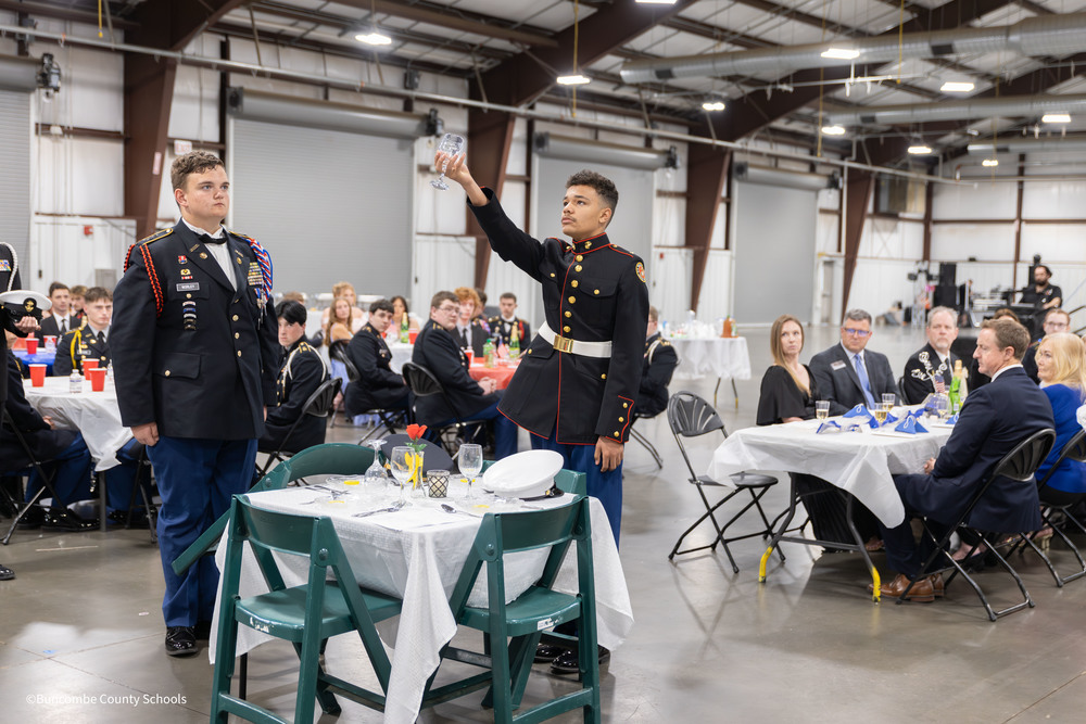 Student raising glass during missing man ceremony