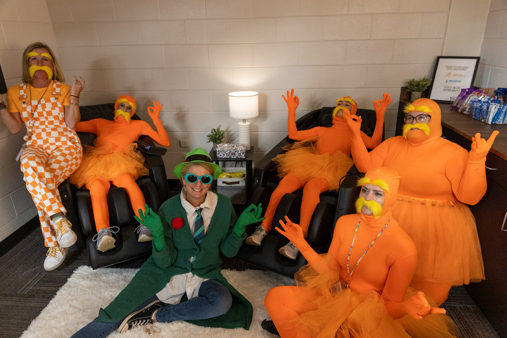 Teachers dressed as Dr. Suess characters do a zen yoga pose sitting in the serenity room at Estes Elementary