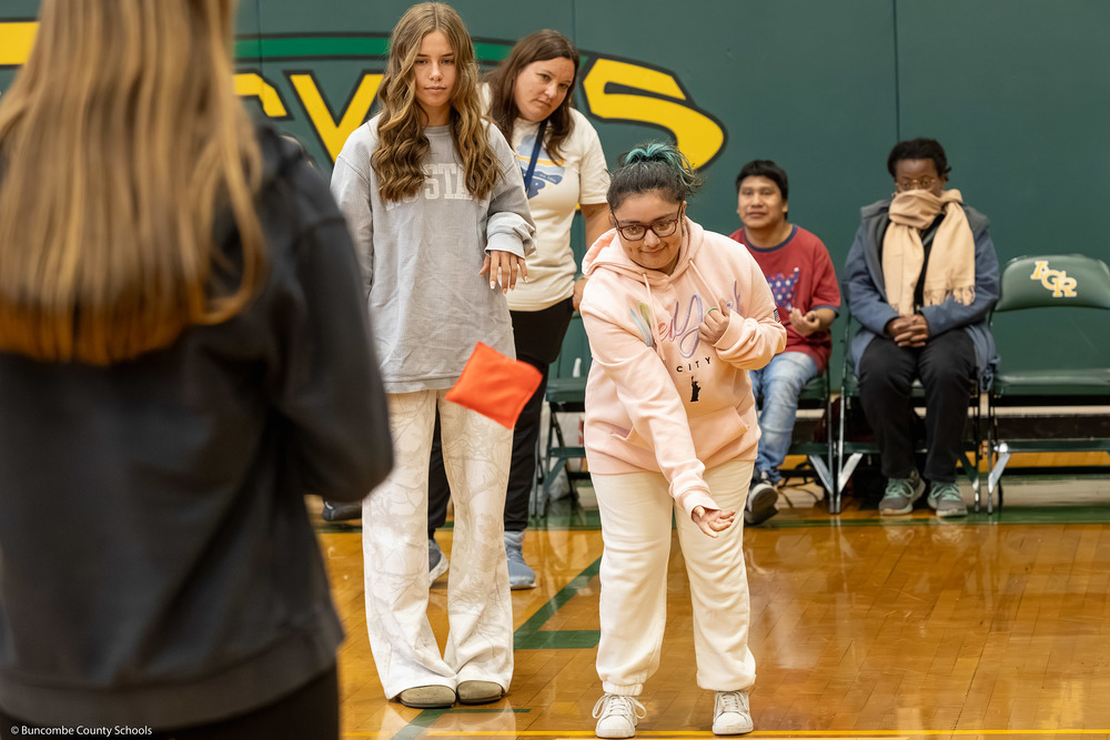 A student tosses a bean bag in the Reynolds High gym.