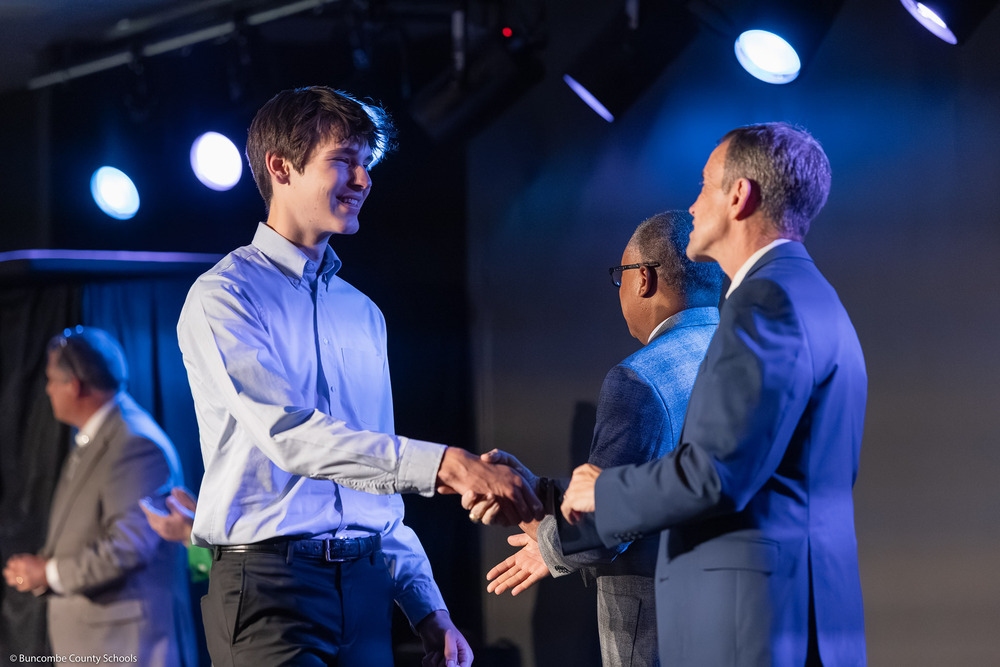 Michael shakes hands with BCS Superintendent Dr. Rob Jackson.
