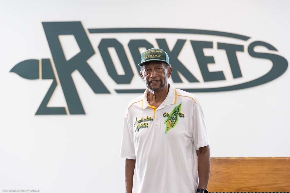 Edgar Waters poses in front of a Rockets sign.