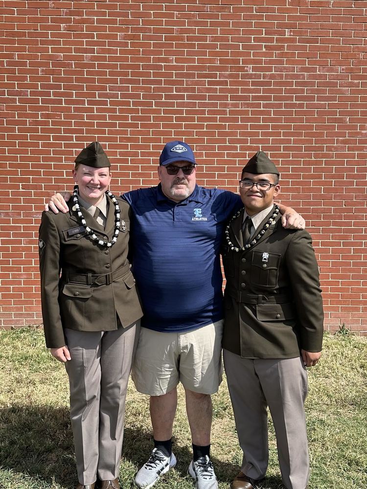 Students Shanon Gobble and Ryan Luther at boot camp graduation with a faculty member from Enka High. 