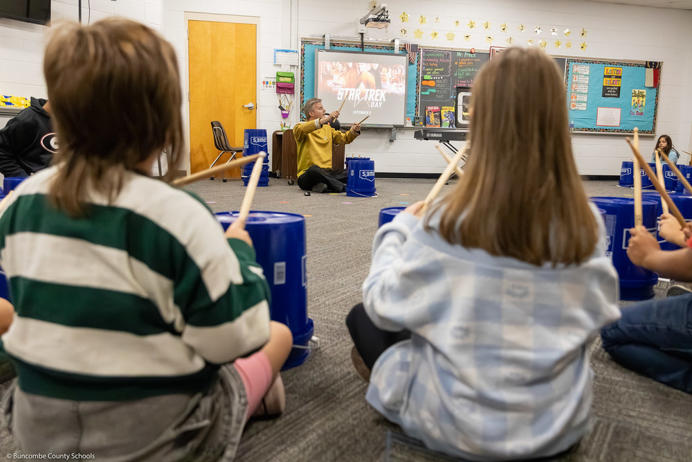 Preston Prince leads kids in a bucket drumming session.