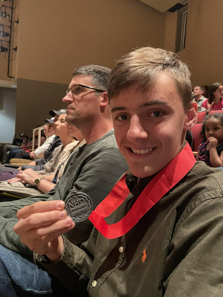 Alex holding up his second place medal at the state competition.