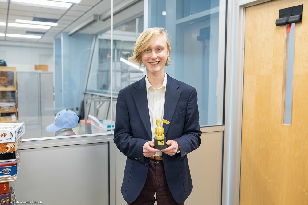 Garrett Armstrong holds a trophy after winning the Geography Bee.