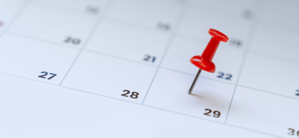 Paper calendar with red pushpin suck in a date