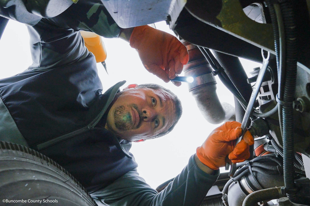bus mechanic working on bus