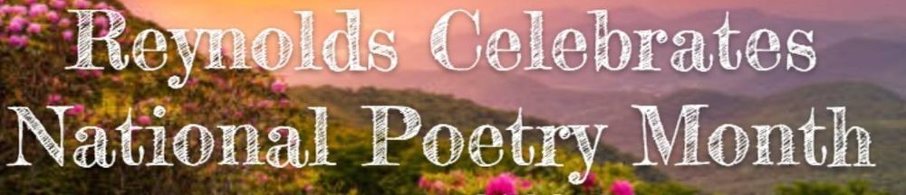 Mountain range in the distance with pink, flowering bushes up front