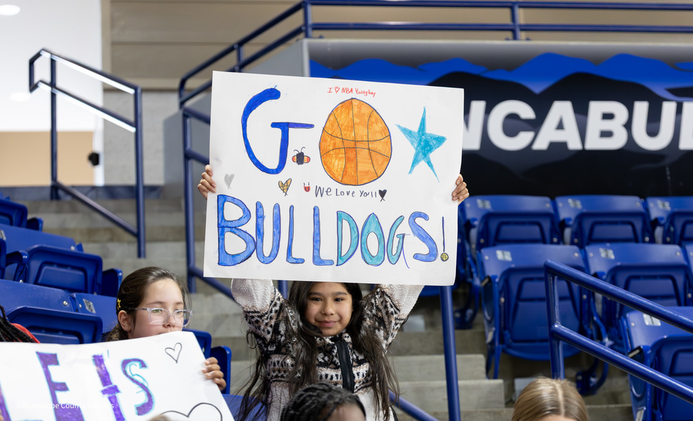 Student holding sign that says "Go Bulldogs"