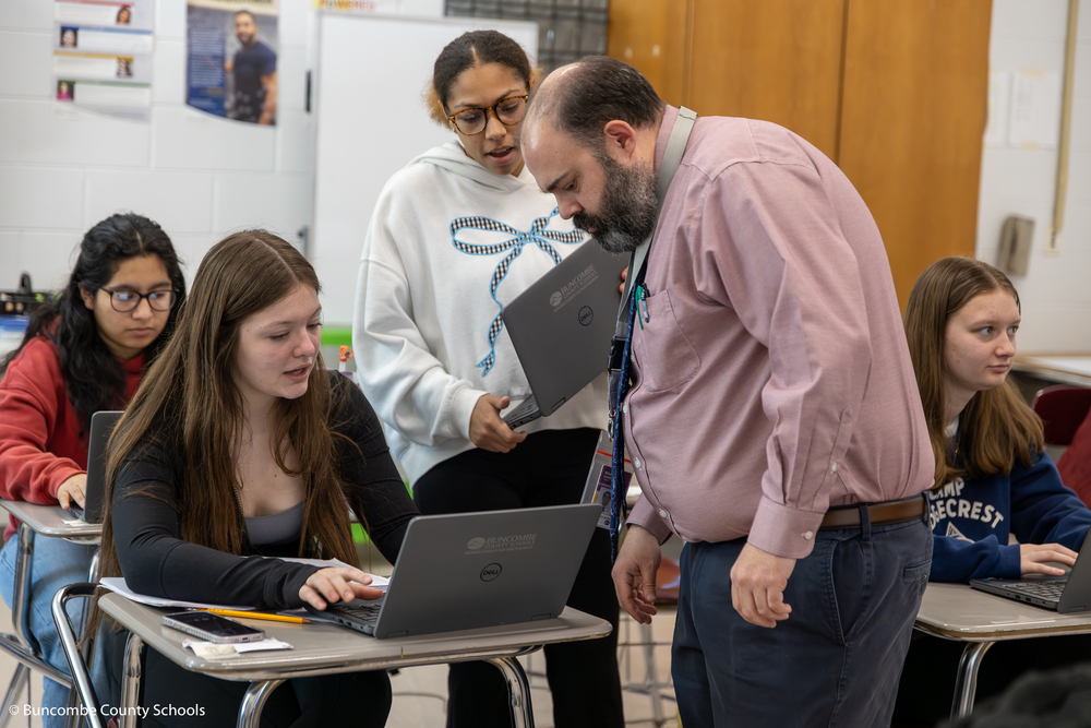 Students working on laptops and using math to create digital artwork. 