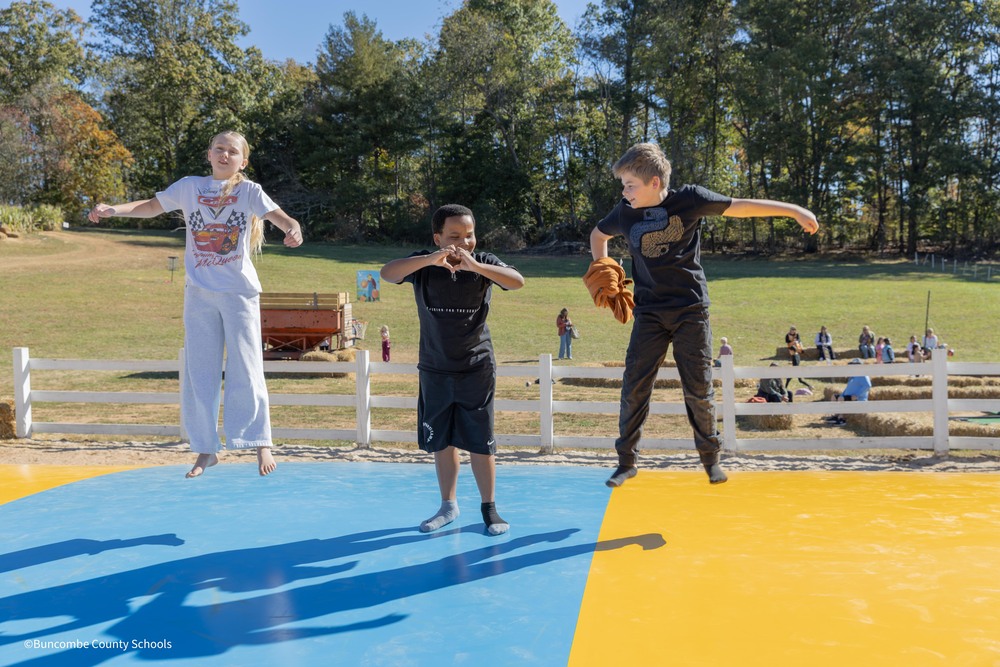 three students jumping 