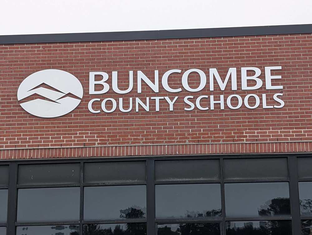 The exterior of the Buncombe County Schools central services building with the Buncombe County Schools logo and sign.