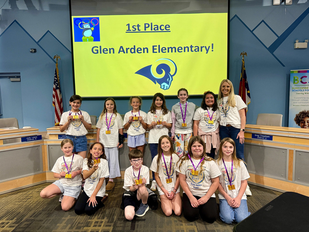 The first place Glen Arden team poses in front of a congratulatory screen.
