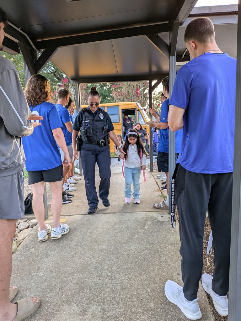 Officer Holden and student head to class