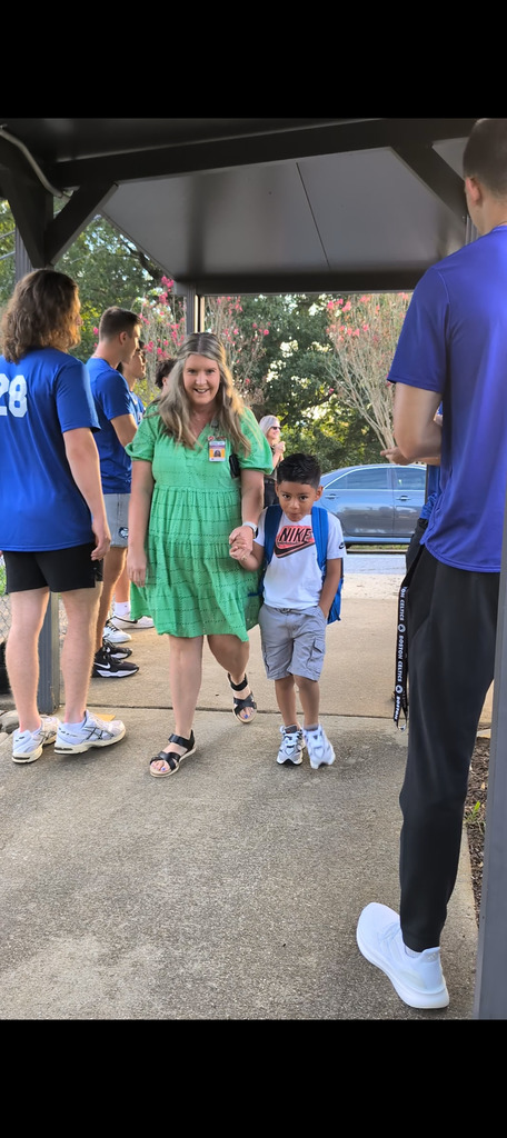 Ms.Wheeler escorts student to class