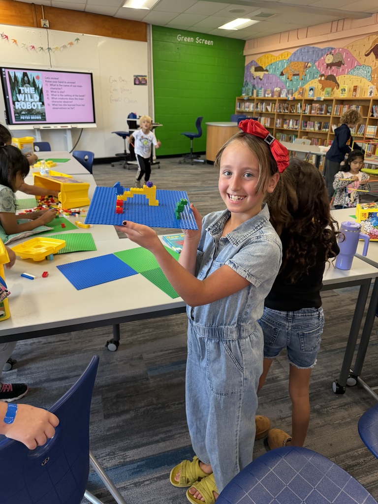 Student holding lego build