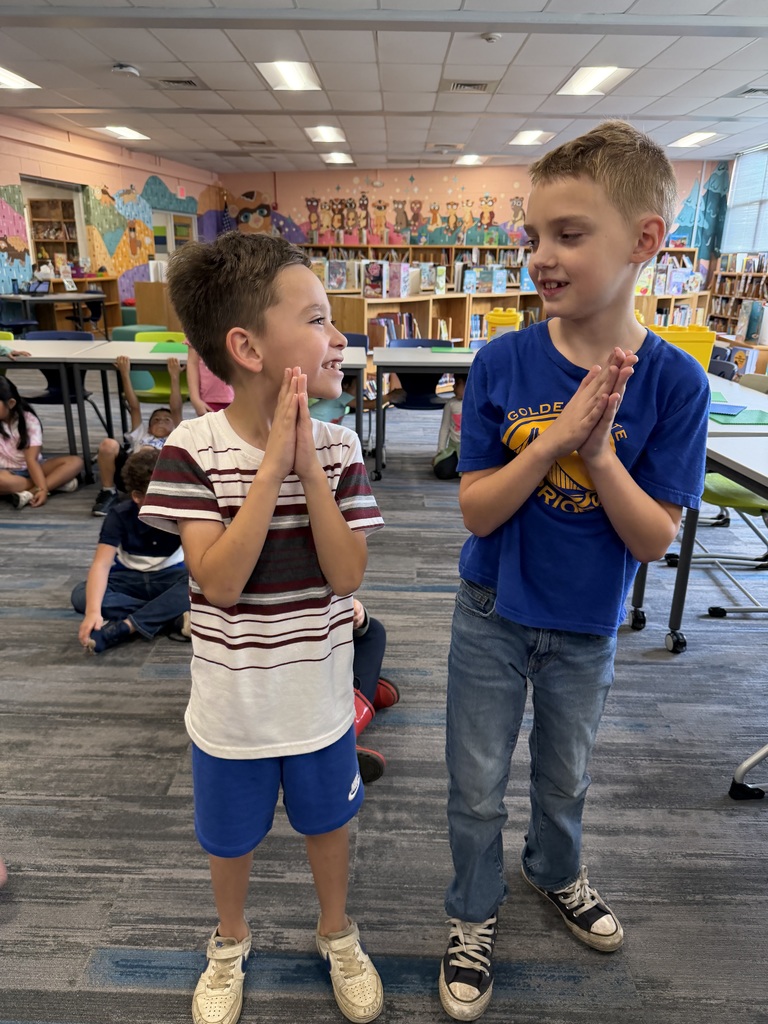 Students practicing their book parts motions