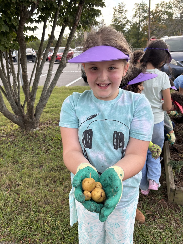 Student holding potato