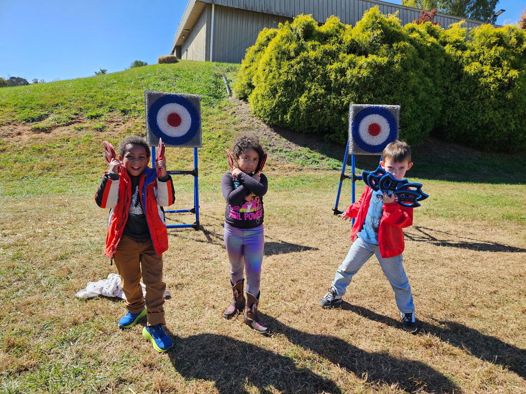 Student pose with axes and target