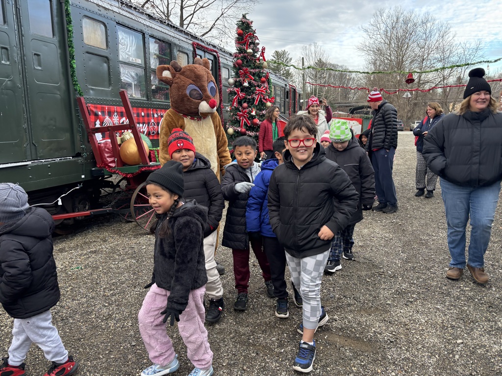 Students walking toward railcar, standing with Rudolph.