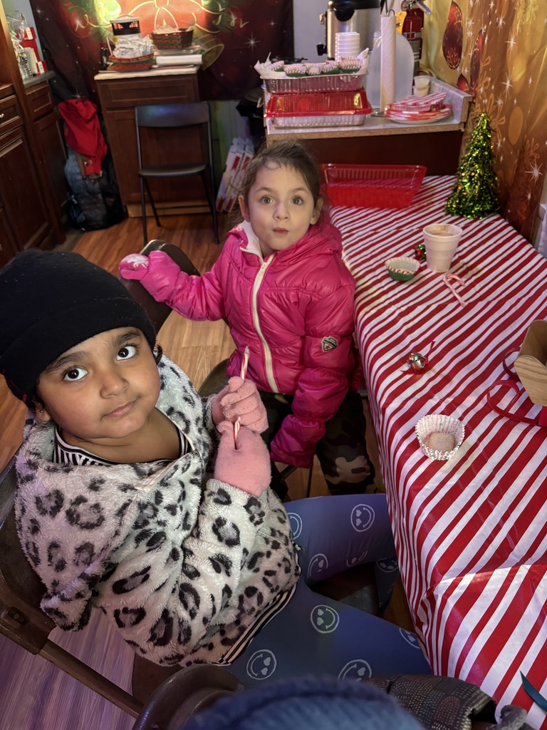 Two students sit enjoying hot cocoa.