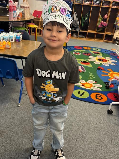 Student smiling in a 100 day hat.