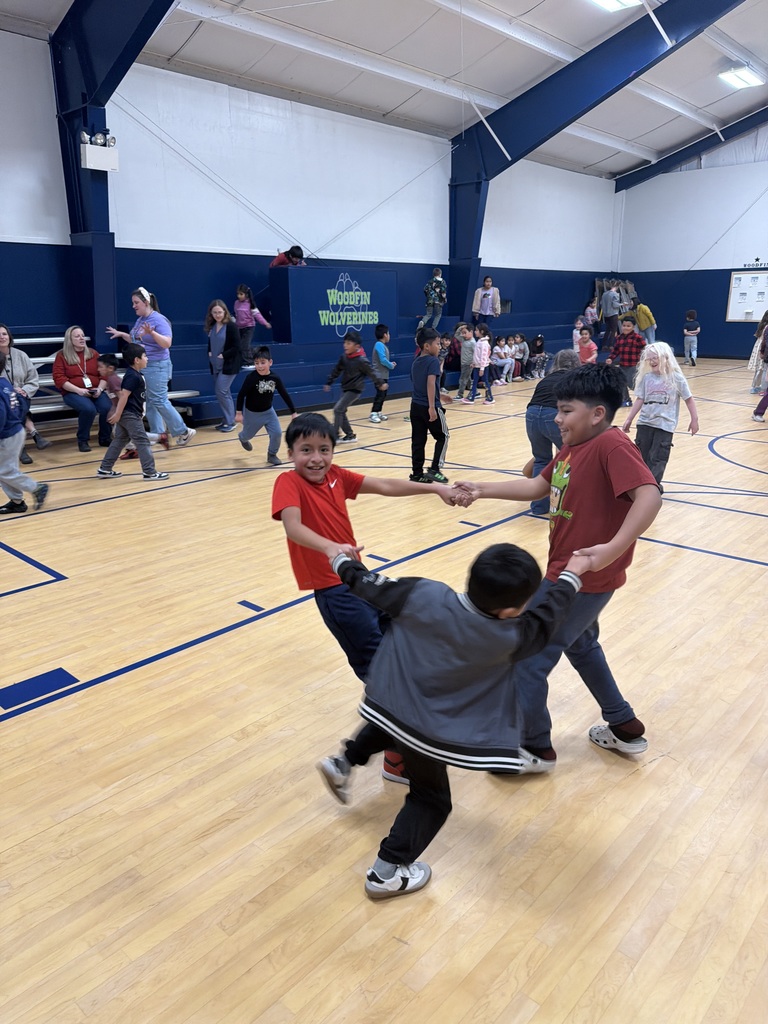 Students hold hands and spin in circle.