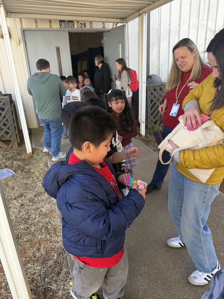 Students smile while getting their Valentine's prizes.