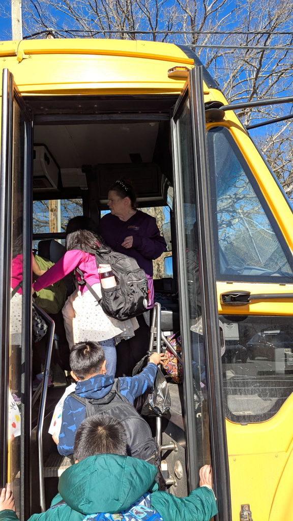 Bus driver on bus smiling.