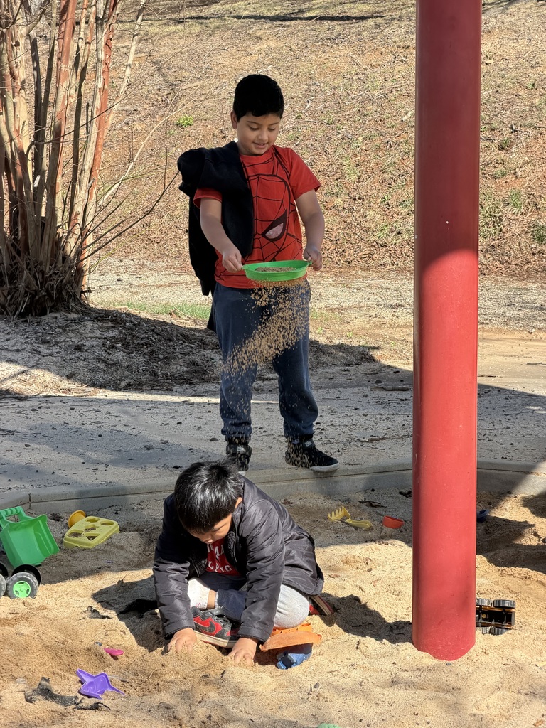 Students play in sandbox.