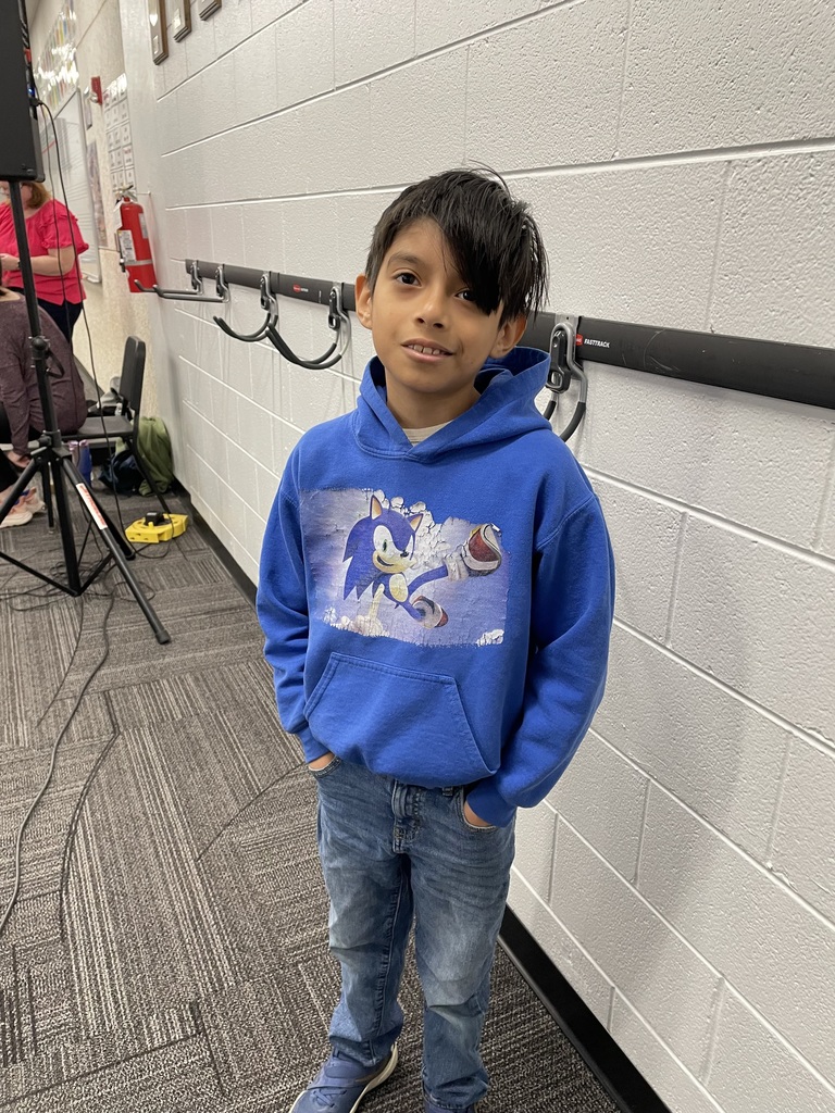 Student stands smiling for photo.