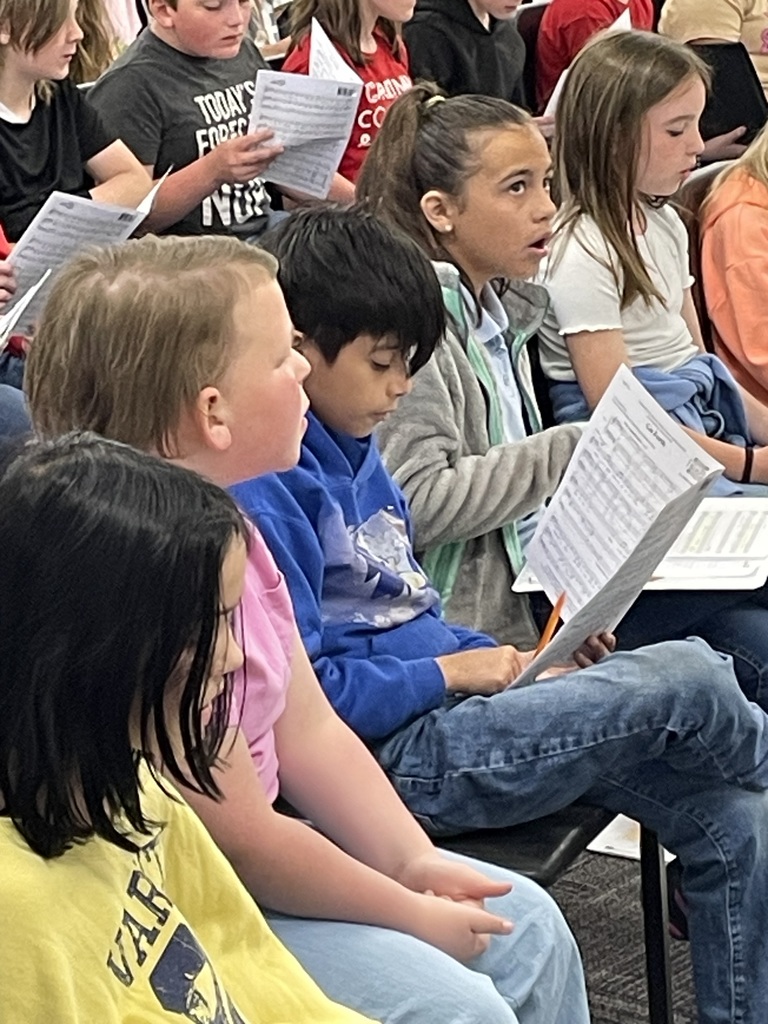 Group of students reading their music sheets.
