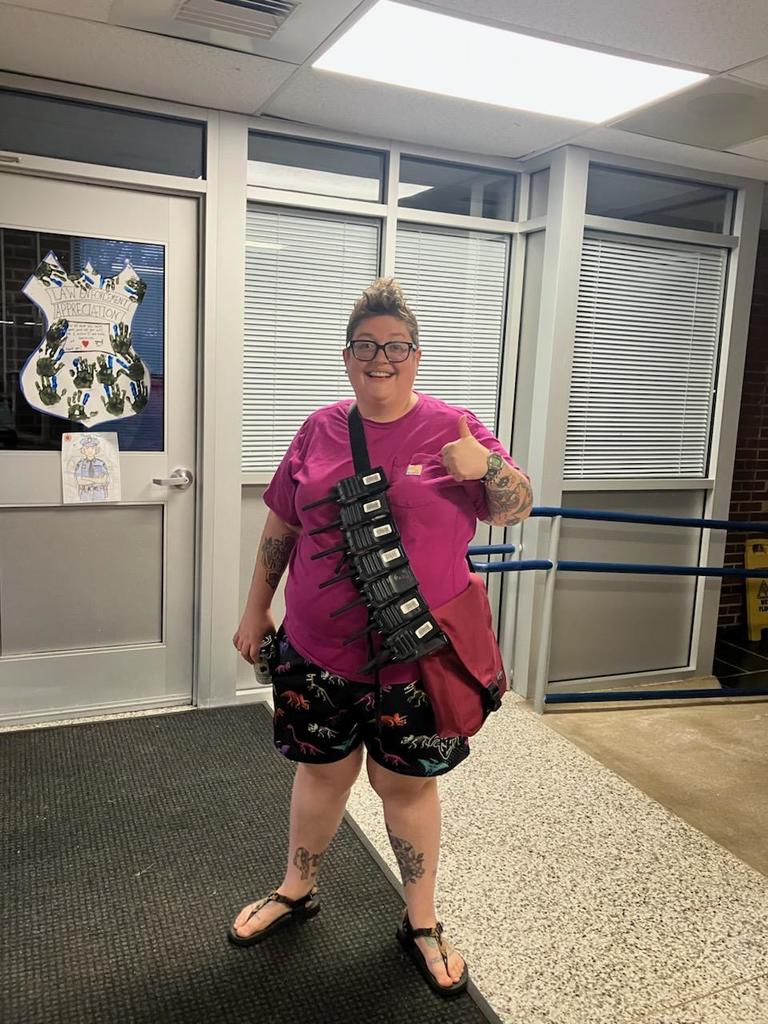 Mrs. Ayers with all of the walkie talkies strapped to her bag ready to lead the parking charge